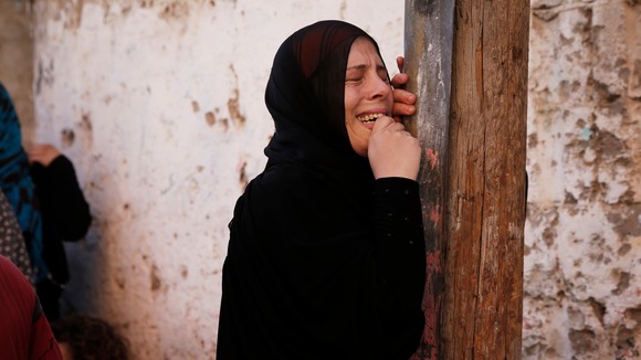 A woman grieves during the funeral of the four Palestinian children