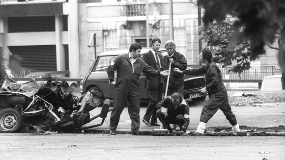 Forensic officers work on the remains of the IRA car which housed the Hyde Park car bomb in which four soldiers died.