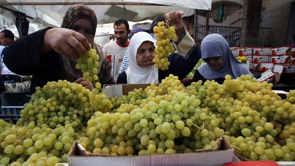 Palestinians shop for food during the humanitarian ceasefire in Gaza.