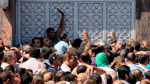 Palestinians wait to withdraw cash from a bank in Gaza.