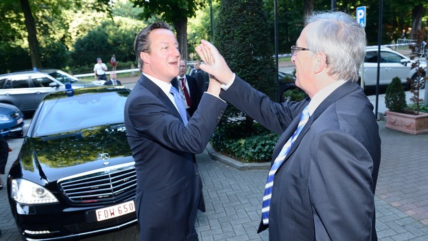 The Prime Minister David Cameron and Jean-Claude Juncker high five as they meet in Brussels