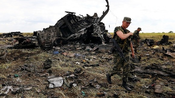 Pro-Russian separatists walk at the site of the crash of the II-76 army transport plane in Luhansk.
