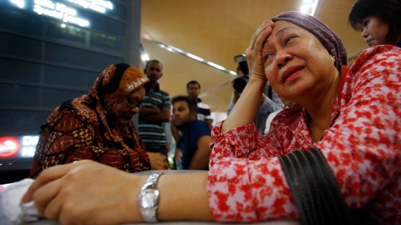 A woman (front), who said she believed her sister was on Malaysia Airlines flight MH-17