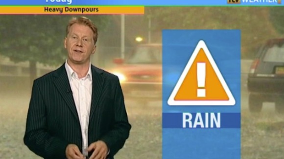 Simon Parkin in front of weather chart