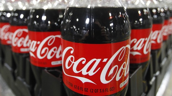 Bottles of Coca-Cola are in a warehouse
