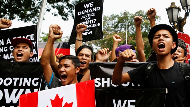 Demonstrators chant slogans outside the Russian embassy in Kuala Lumpur.
