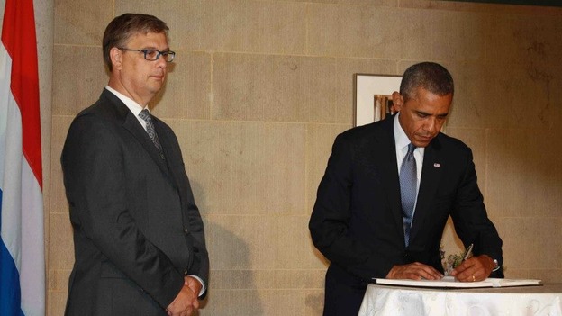 Barack Obama signing a book of condolence.