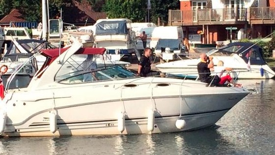 Boat with people searching for boy on River Thames