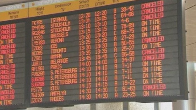 A departure board at Tel Aviv airport shows various cancelled flights.