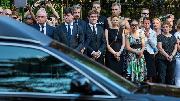 Devastated family members of victims look on as the hearses arrive at the Korporaal van Oudheusden barracks.