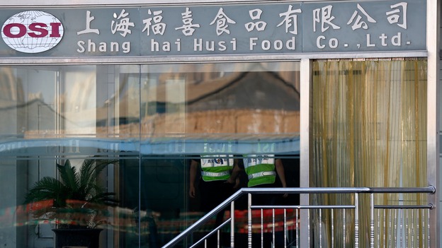 Security guards stand inside the OSI group where the meat is alleged to have been processed.