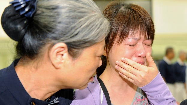 Relatives of a passenger on board the crashed TransAsia Airways plane cries.