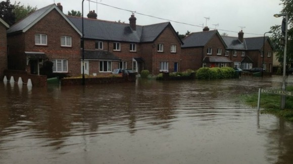 Houses in Angmering, West Sussex, surrounded by flood water.