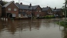 Houses in Angmering, West Sussex, surrounded by flood water.