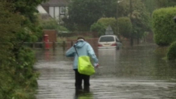 Paperboy Luke Wayne battles his way through severe flooding in Limmer Lane, Felpham to do his round.