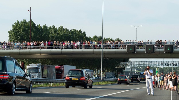 People line the roadside