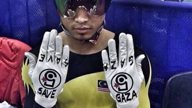Malaysia's Azizulhasni Awang holds up his gloves to the camera.