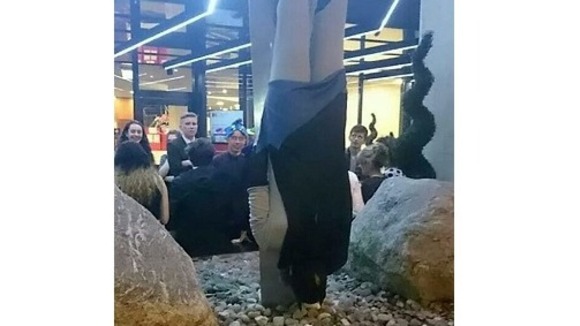 'Batman' surprises these people with his hanging antics.