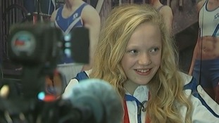 Erraid Davies smiles as she is interviewed with her bronze medal around her neck.