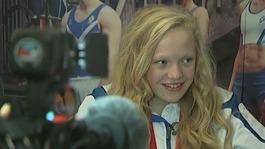 Erraid Davies smiles as she is interviewed with her bronze medal around her neck.