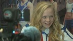 Erraid Davies smiles as she is interviewed with her bronze medal around her neck.