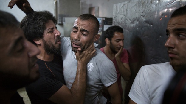 A Palestinian father at a hospital morgue in Gaza after his son was killed in an explosion.