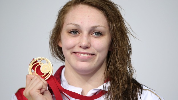 England's Sophie Taylor on the podium with her Gold medal as she celebrates victory in the Women's 100m Breaststroke Final