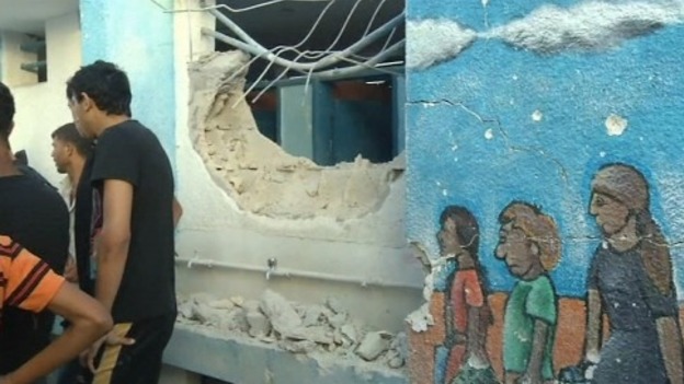 A hole is shown in the side of the school in northern Gaza.