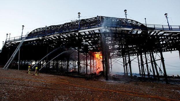 Firemen continue to tackle the final flames of a fire at Eastbourne Pier on Wednesday evening.