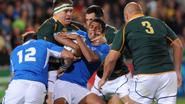Chrysander Botha of Namibia (centre) is tackled during Rugby World Cup