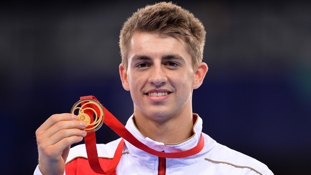 Max Whitlock holds his third gold medal of the Commonwealth Games.