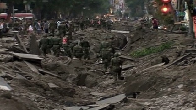 Rescue teams survey the aftermath of the five explosions.