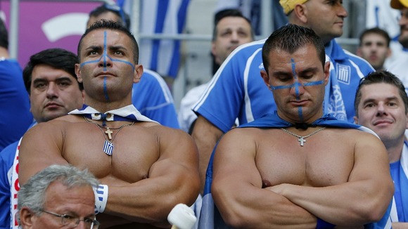 Two dejected Greece fans struggle with defeat by the Czech Republic.