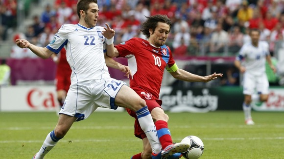 Greece's Costas Fortounis, left, and Czech Republic's Tomas Rosicky fight for the ball.