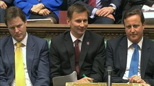 Culture Secretary Jeremy Hunt sits flanked by Prime Minister David Cameron and Deputy Prime Minister Nick Clegg.