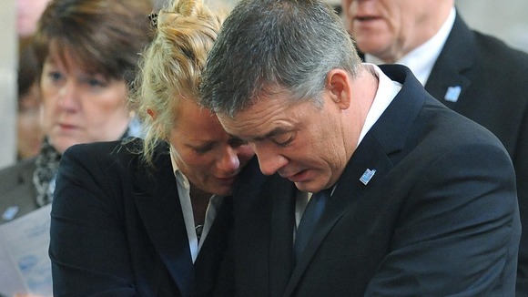 Darren Rathband, twin brother of Pc David Rathband, is supported by his fiancee Angie Stephenson during a memorial service