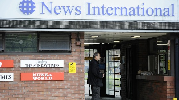 A security guard stands at the entrance to News International offices in Wapping last summer
