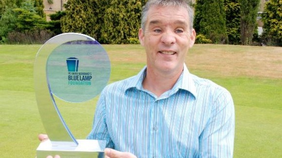 PC David Rathband holds a Blue Lamp Foundation trophy