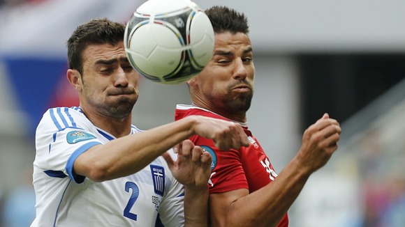 Greece's Yiannis Maniatis, left, and Czech Republic's Milan Baros fight for the ball in Wroclaw.