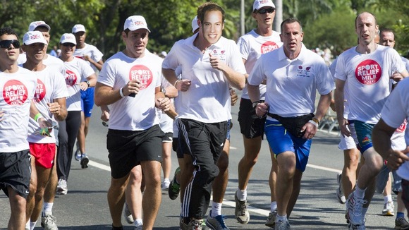 Prince Harry runs a mile for charity wearing a mask with Prince William's face on it