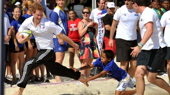 A child tries to take Harry down during the game