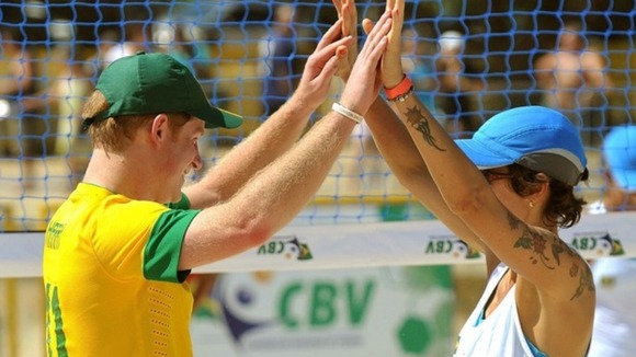 Harry celebrates with a team mate during a game of volleyball