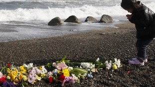 Girl prays for victims of the earthquake and tsunami in Iwaki