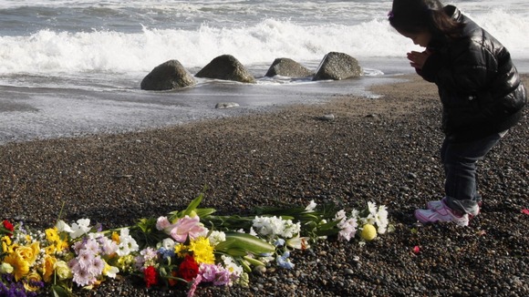 Girl prays for victims of the earthquake and tsunami in Iwaki