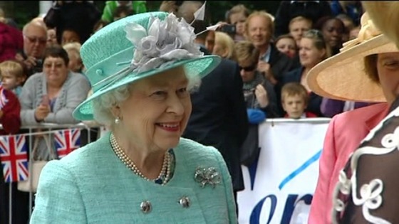 The Queen smiles at well-wishers as she arrives in Corby