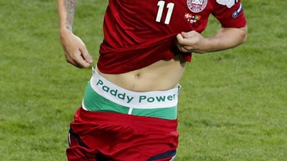 Denmark striker Nicklas Bendtner shows off his 'Paddy Power' underwear.
