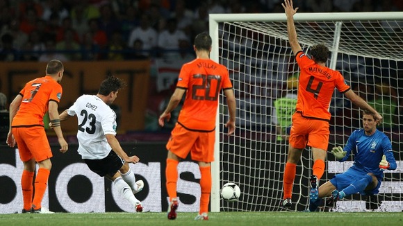 Germany striker Mario Gomez scores his first goal of the game.