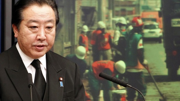 Japanese Prime Minister Yoshihiko Noda speaks in front of an image of disaster-hit areas