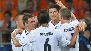 Germany players congratulate goalscorer Mario Gomez