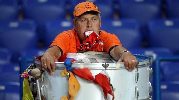 Dutch fan with drum in shock after defeat to Germany
